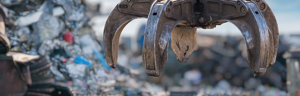 Close up View On Mechanical Arm Claw Of Crane At Landfill.