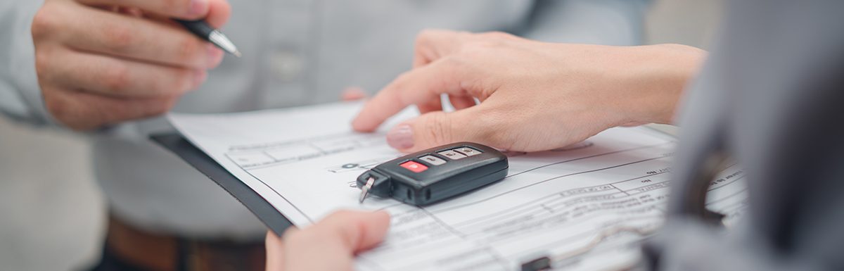 Car Sale Or Rental Concept, Closeup Dealership Manager Signing Car Insurance Document Or Lease Paper Contract. Customer With Car Dealer Agent Making Deal, Sign On Agreement Document Contract In Office
