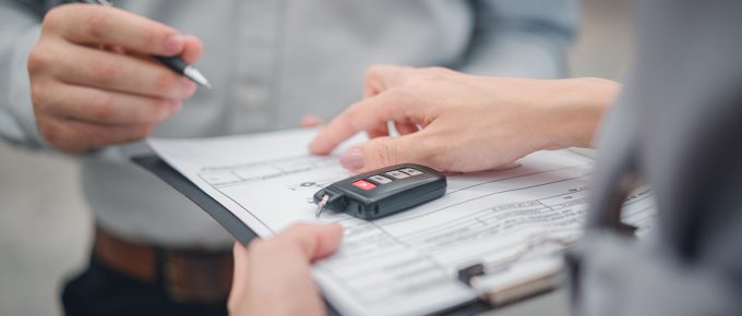 Car Sale Or Rental Concept, Closeup Dealership Manager Signing Car Insurance Document Or Lease Paper Contract. Customer With Car Dealer Agent Making Deal, Sign On Agreement Document Contract In Office